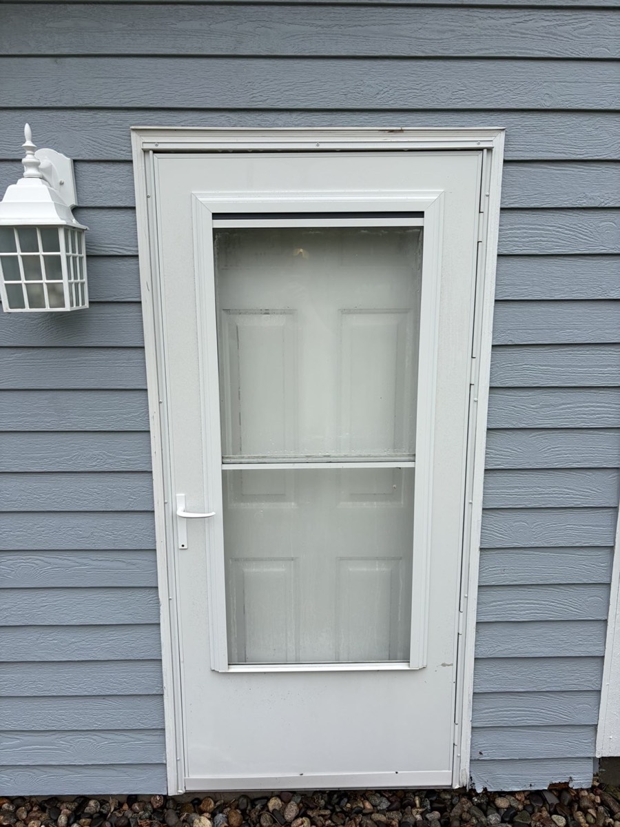 Storm door after washing — clean white frame and clear glass