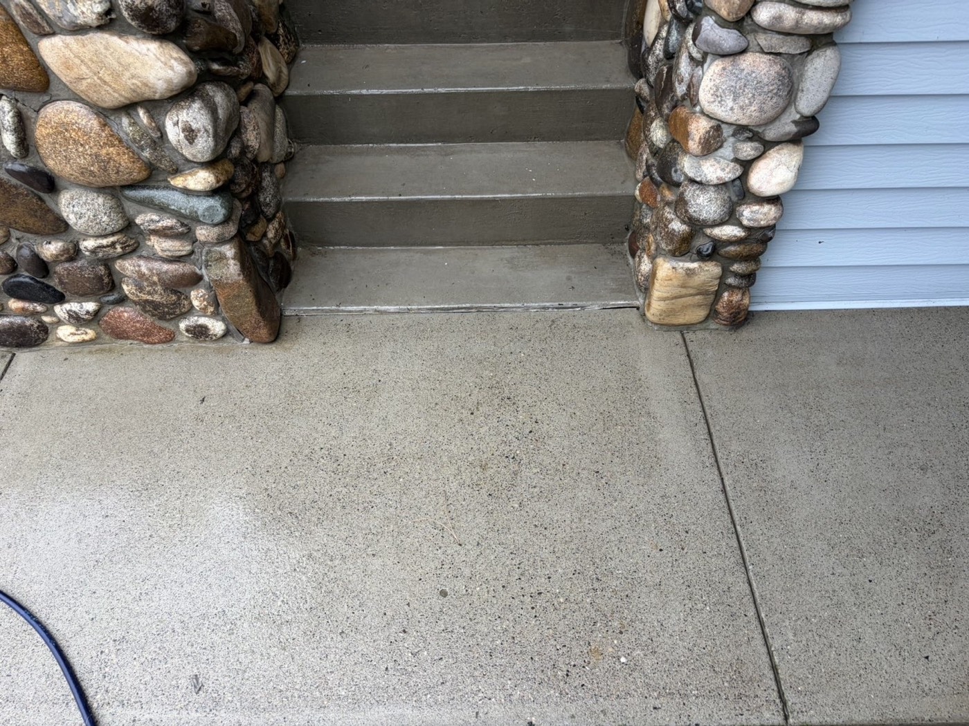 Porch landing after cleaning — the dark stain lifted away